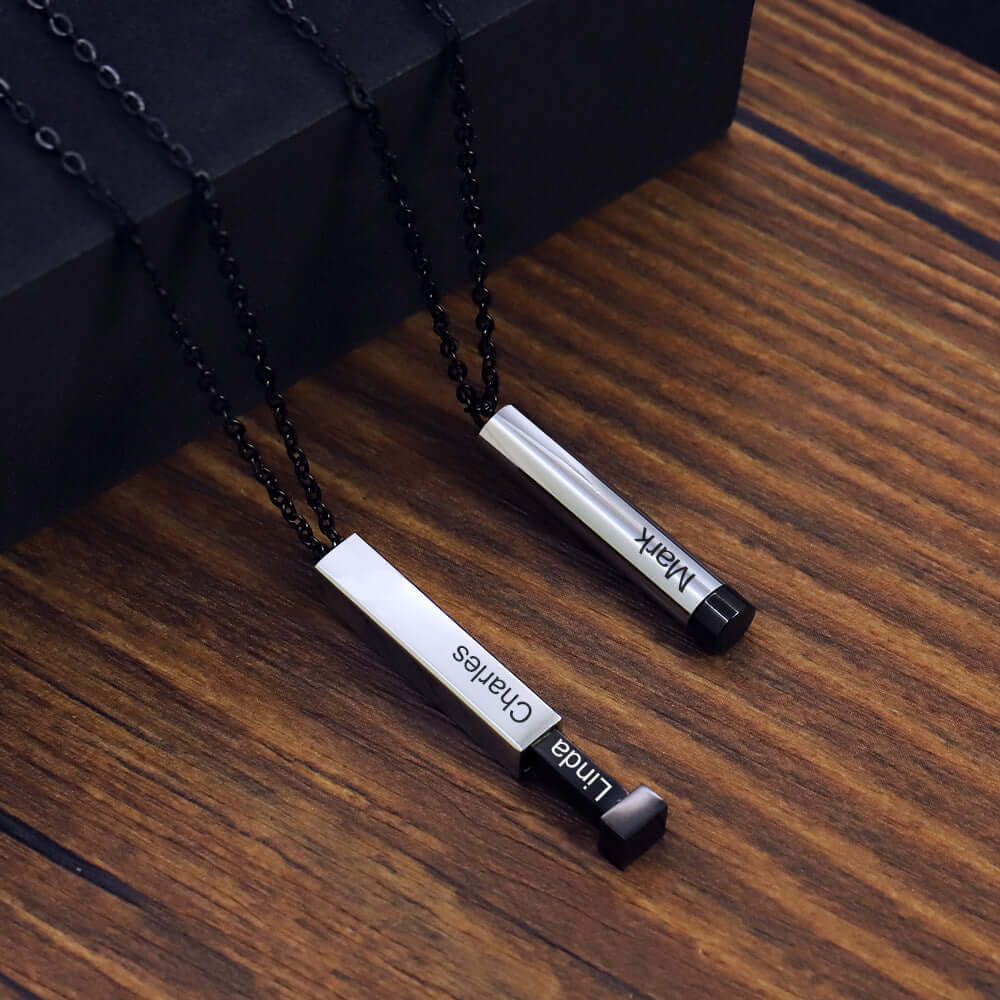 Two of the personalized name necklaces for lovers. One is a square variant in black with the names Charles and Linda and the other is a Cyclinder variant with the name mark on it.