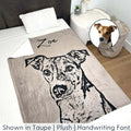 The personalized pet photo blanket with a dog and the name Zoe printed on it, on a bed in a bedroom. A small graphic in the corner of a real dog.